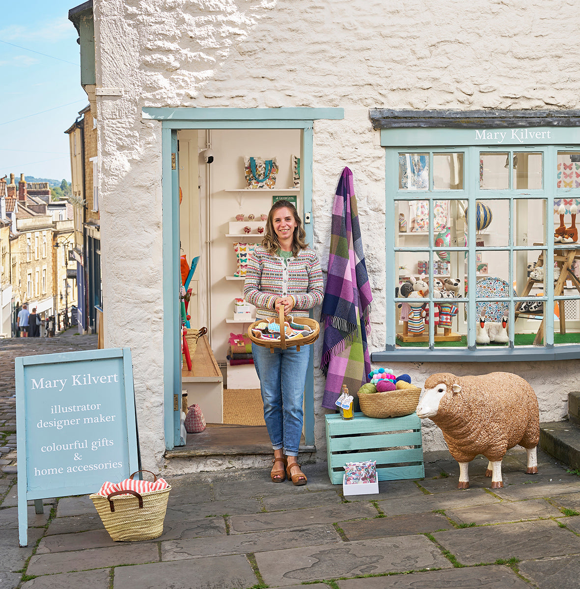 Mary Kilvert standing by the doorway of her shop in Frome, Somerset