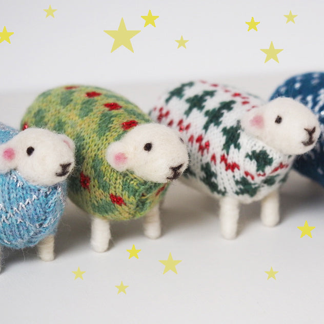 Felted sheep in jumpers in a row, made by Mary Kilvert