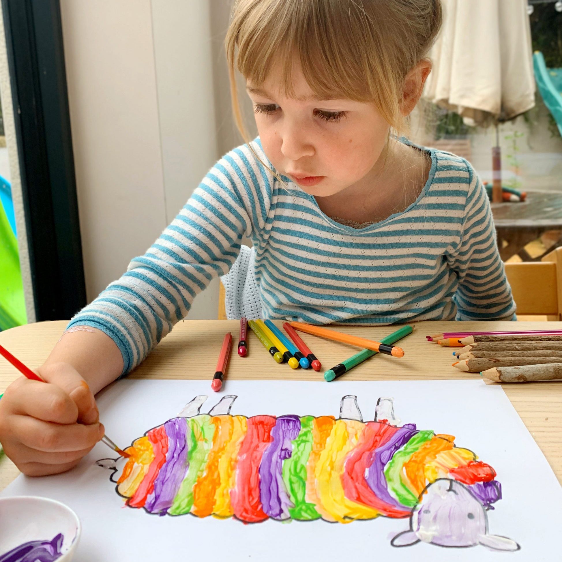 A girl painting a picture of a sheep for a Mary Kilvert Competition