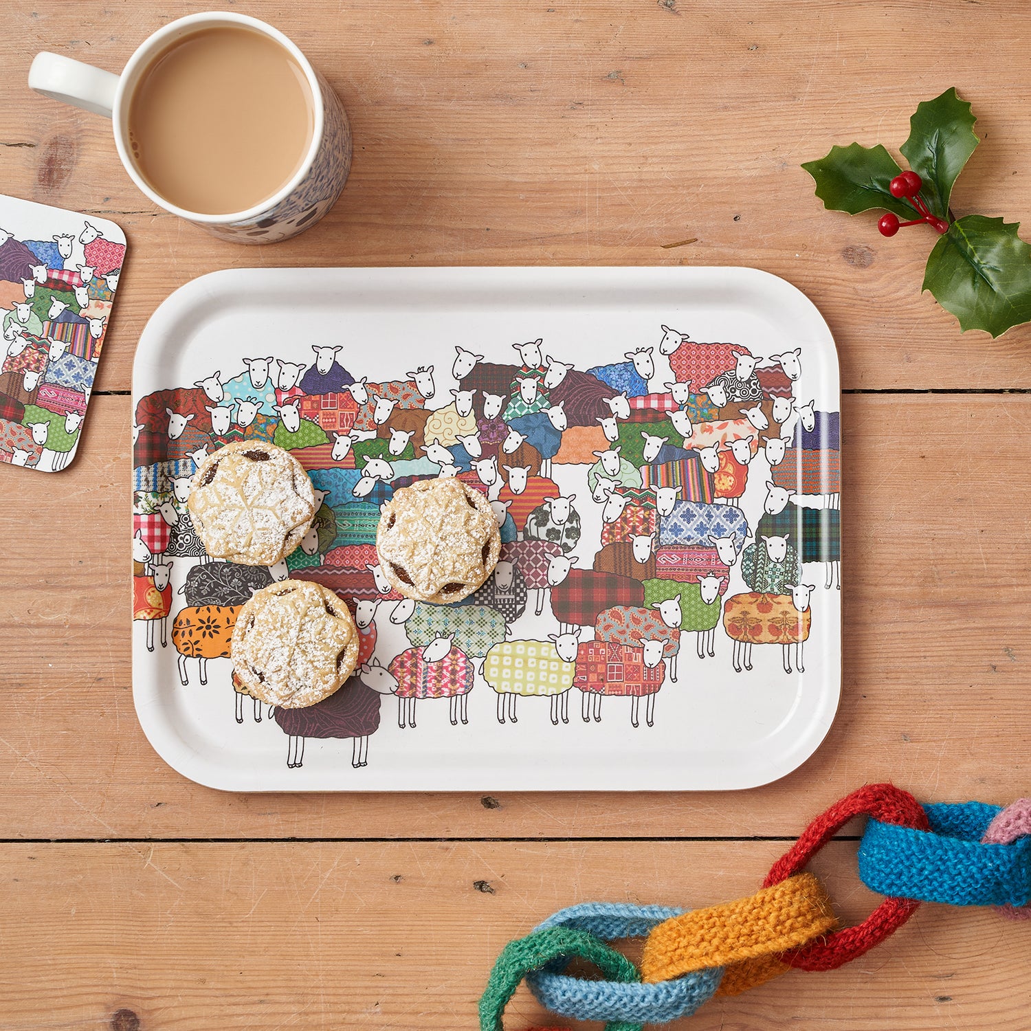Colourful Sheep Tray, Coaster and Mug by Mary Kilvert, on a Christmas table setting